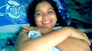 Shy Indian girl covering herself with bedsheet